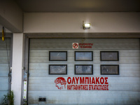 a garage door where is red lettering olympiakos nautical facilities