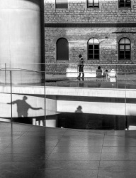 visitors and their shadows at the entrance of the acropolis museum in athens, black-and-white