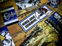 blue-white stickers of the football club hsv are sticking on an old wooden table in the unabsteigbar in hamburg
