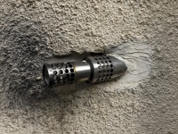 a motorcycle exhaust is cemented in a wall at a house in diakopto