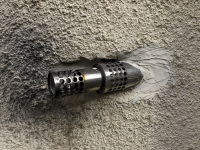 a motorcycle exhaust is cemented in a wall at a house in diakopto
