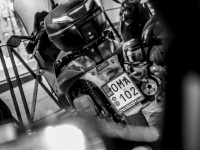 in rhodes city is standing a motorcycle with a license plate lettering oma, the german word for grandma, black-and-white