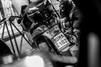 in rhodes city is standing a motorcycle with a license plate lettering oma, the german word for grandma, black-and-white