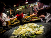 a group of young men is eating in the restaurant memphis bbq grill in rhodes city, in front you see the best ceasar salad in the world