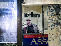 signs of advertising for cigarettes marlboro, karelia and assos in front of the restaurant mavrios in archangelos on rhodes