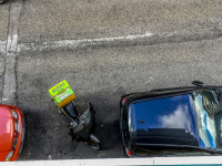 view from a balkon in ioannina on the street with parking cars and a pizza service motorcycle