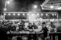 a busy funfair stand with suflaki in kremasti on rhodes, black-and-white