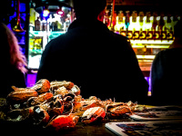 behind empty peanut shells are standing a young man at the bar of the papa joe\'s jazzokal in cologne