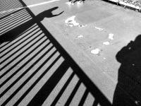 black shadows of a railing and of two people at the hohenzollernbrücke in cologne