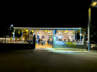 cozy greek taverna-limnioni in stegna-rhodes with customers by night