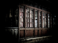 an old and dilapidated wooden veranda with damaged windows in profitis ilias on rhodes