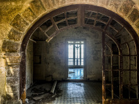 view in the ruine of the mussolini villa in profitis ilias on rhodes, with a window in the background and grafitti at the walls