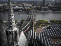 a view from the dom of cologne to the hohenzollernbrücke and the rhine, black-and-white