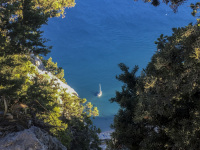 a white boat from above in the blue sea at tsambika beach on rhodes