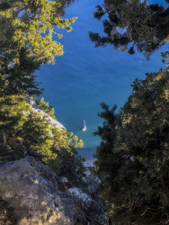a white boat from above in the blue sea at tsambika beach on rhodes