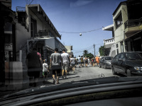 with a view from a mercedes CLK on a group of tourist, which are going in the middle of the street in embonas on rhodes