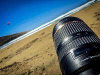 a big tamron lens takes pictures of kitesurfer at the prasonissi beach on rhodes