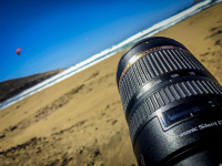 a big tamron lens takes pictures of kitesurfer at the prasonissi beach on rhodes