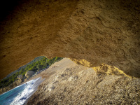 a big yello rock in front of the fourni beach on rhodes