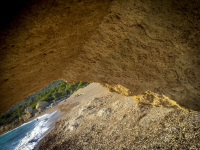 a big yello rock in front of the fourni beach on rhodes
