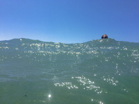 the blue sky at the top and in front the turquoise sea of prasonisi in rhodes, a head is between the scene