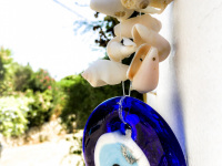 a nazar-amulet with shellfish is hanging in athina\'s garden in stegna on rhodes
