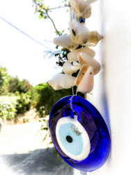 a nazar-amulet with shellfish is hanging in athina\'s garden in stegna on rhodes
