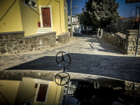 a CLK ist standing in mesanagros on rhodes, the village and the mercedes star are reflected on the cowling