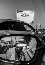 at the border crossing from serbia to hungary with a view in a rear mirror, where you see traffic jam, black-and-white