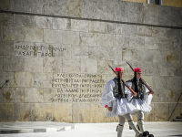 two evzones are making a change of guard in front of the greek parliament at synthagma in athens