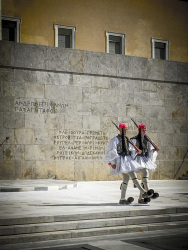 two evzones are making a change of guard in front of the greek parliament at synthagma in athens