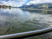 view from a railing to the lake pamvotida and the mountains in ioannina