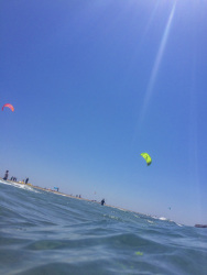 very close standing at the sea in prasonisi on rhodes you see in the distance kitesurfer at the beach