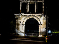 the spotlighted arch of hadrian in athens by night