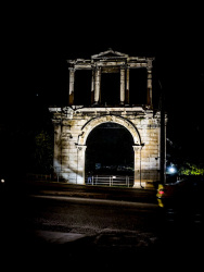 the spotlighted arch of hadrian in athens by night