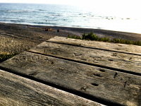 an old wood table with carvings are in the front of the limni beach near apolakkia on rhodes