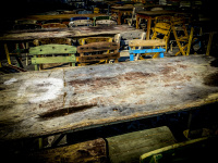 old wood chairs and wood tables are standing ready for a folk festival in the sun in psinthos on rhodes for a