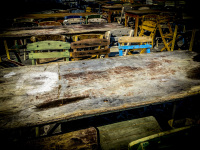 old wood chairs and wood tables are standing ready for a folk festival in the sun in psinthos on rhodes for a
