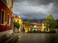 colorful little houses are illiuminated by the evening sun in ioannina