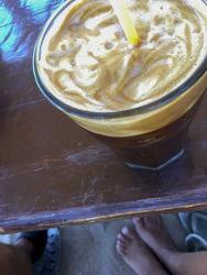 at tsambika beach on rhodes a big frappee with many coffefoam stands on a wooden table