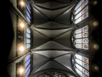 the vault of the dom in cologne with four gothic domes and at the side colorful church windows