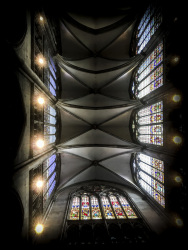 the vault of the dom in cologne with four gothic domes and at the side colorful church windows