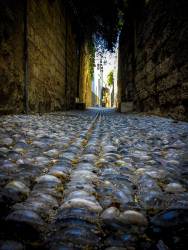 big cobblestones in the front lead through a street in the old town in rhodes city