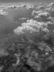 view on loveley little clowds and under it is a landscape near hamburg in germany, black-and-white