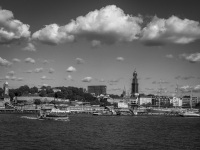 the skyline of hamburg with the elbe, with the michael church and with loveley clowds at the sky, black-and-white