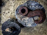 rusted hooks are draped on grey tree stumps in athinas garden in stegna on rhodes