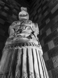 a big statue in the palace of the grandmaster of the knights of rhodes, black-and-white