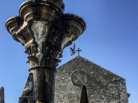the church evangelismou and a fountain with a pigeon at a bly sky at the mandraki harbor on rhodes