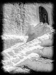 white limed steps lead to a dark wooden door in the village lindos on rhodes, black-and-white