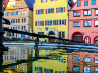 colorful houses at the marketplace in rothenburg ob der tauber in germany are relected in the water of a fountain